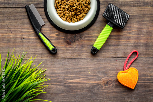 grooming tools for training pet and brushes on wooden background top view mock-up
