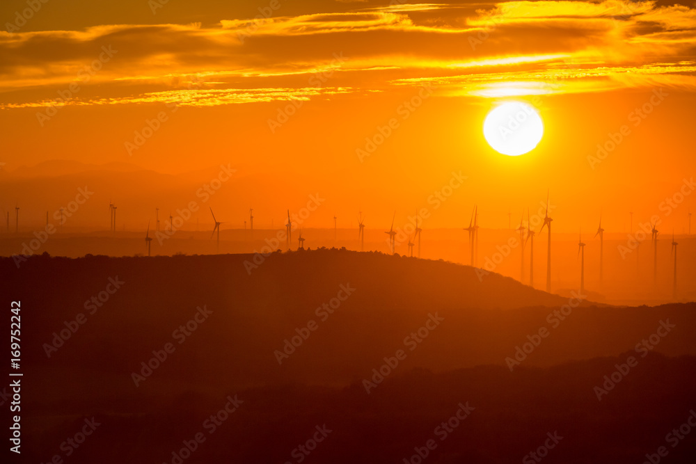 Silhuettes of wind power generators back lit at sunset, near Vienna, Austria Silhuettes of wind power generators back lit at sunset, near Vienna, Austria