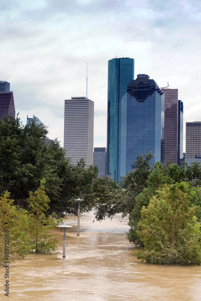 The consequences of the spill Buffalo Bayou River in Houston. Flooded park on Downtown city background. Hurricane Harvey The consequences of the spill Buffalo Bayou River in Houston. Flooded park on Downtown city background. Hurricane Harvey