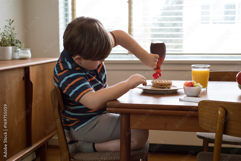 Side view of boy having breakfast Side view of boy having breakfast