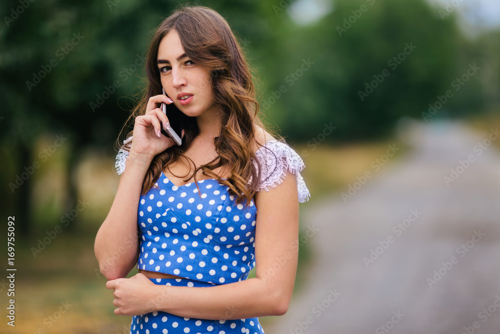 Young beautiful woman talking on smartphone in the street Young beautiful woman talking on smartphone in the street