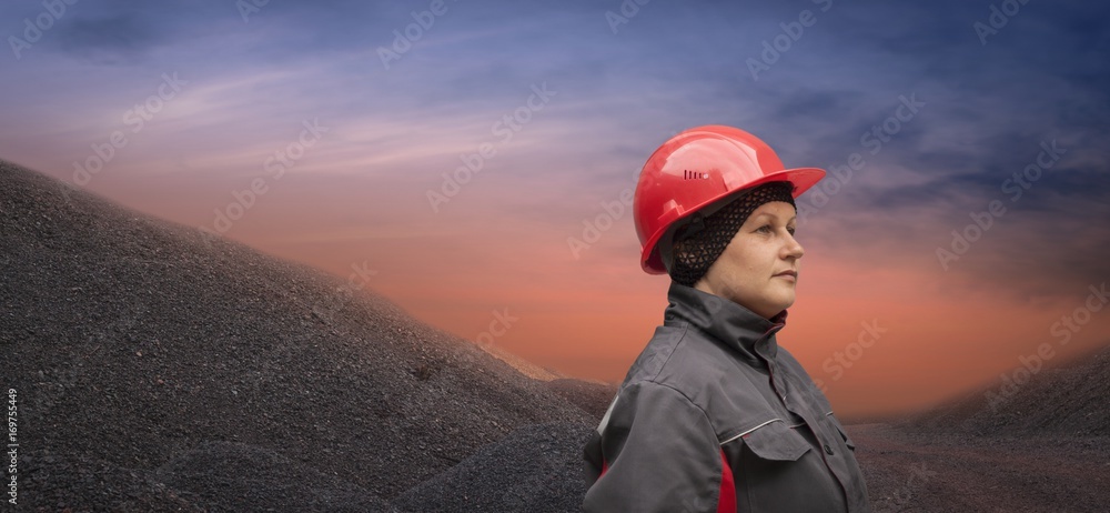 A helmet for protection of the head. Working gloves. The woman in working to protective clothes . Safety equipment . A helmet for protection of the head. Working gloves. The woman in working to protective clothes . Safety equipment .