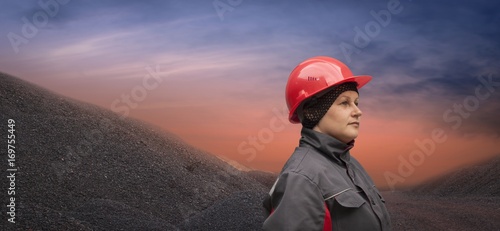 A helmet for protection of the head. Working gloves. The woman in working to protective clothes  . Safety equipment . 