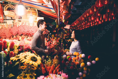 Happy couple shopping in Chinatown over Chinese New Year photo