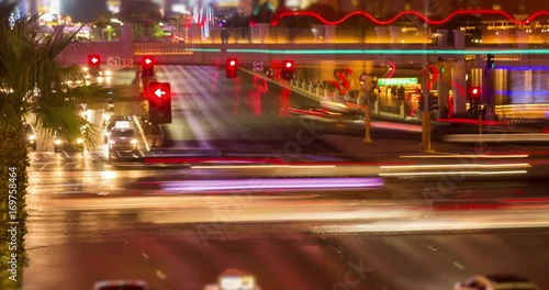 Las Vegas Intersection Traffic Night Time-lapse. a time-lapse of the Las Vegas Intersection at Flamingo Rd with traffic moving fast with light streaks and commotion
 photo