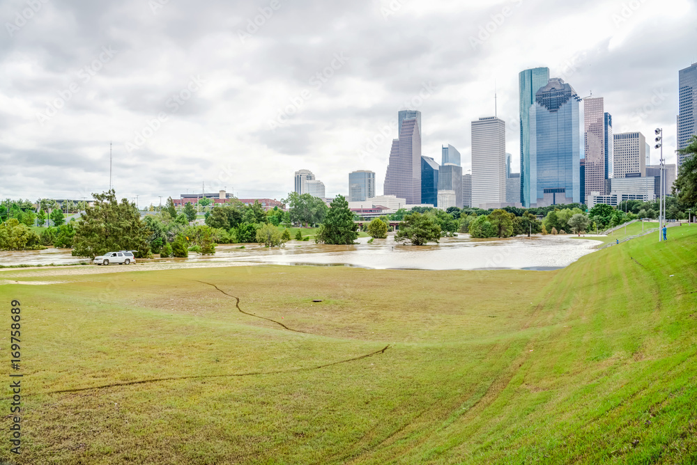 Downtown Houston at daytime with storm cloud sky and rare high water flood on Eleanor Park because of Harvey Tropical Storm. Heavy rains from hurricane Harvey caused many flooded areas in Houston
