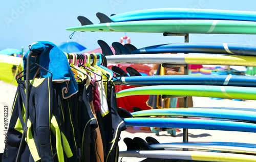 Canvas Print Surfboards and uniforms on the beach at the surf school