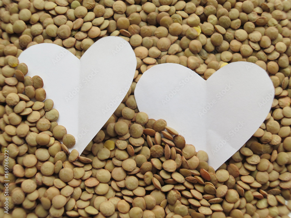 Detail of White Heart shape on of raw lentils background Detail of White Heart shape on of raw lentils background