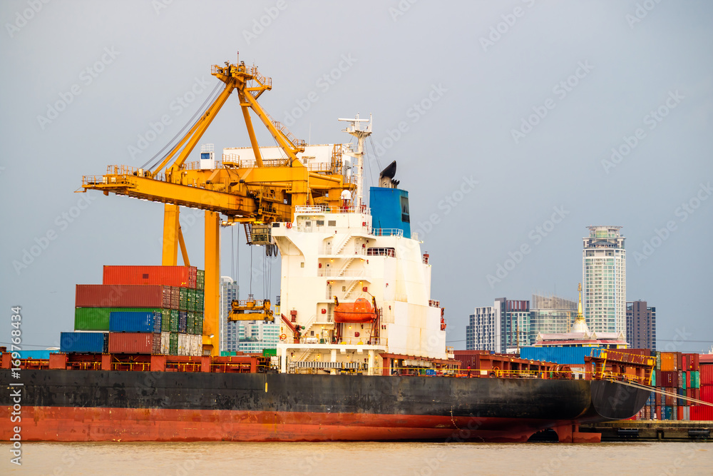 Shipping trade port. Container cargo ship loading or unloading by crane bridge. Logistics industrial and transportation business background Shipping trade port. Container cargo ship loading or unloading by crane bridge. Logistics industrial and transportation business background
