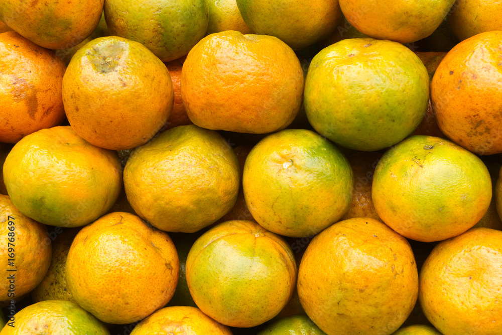 Pile of fresh tangerines ready to sell in the supermarket Pile of fresh tangerines ready to sell in the supermarket