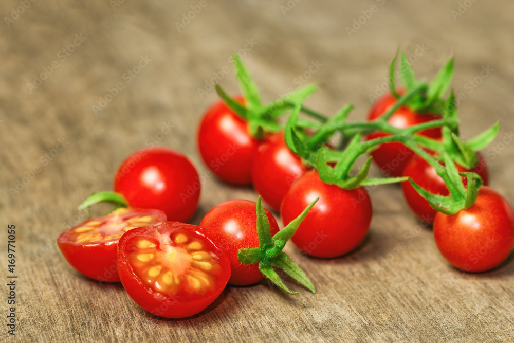 Fresh cherry tomato on rustic wood table. Close up lovely cherry tomato for background or wallpaper. Prepare fresh cut cherry tomato for home cooking look so delicious. Macro concept with copy space. Fresh cherry tomato on rustic wood table. Close up lovely cherry tomato for background or wallpaper. Prepare fresh cut cherry tomato for home cooking look so delicious. Macro concept with copy space.