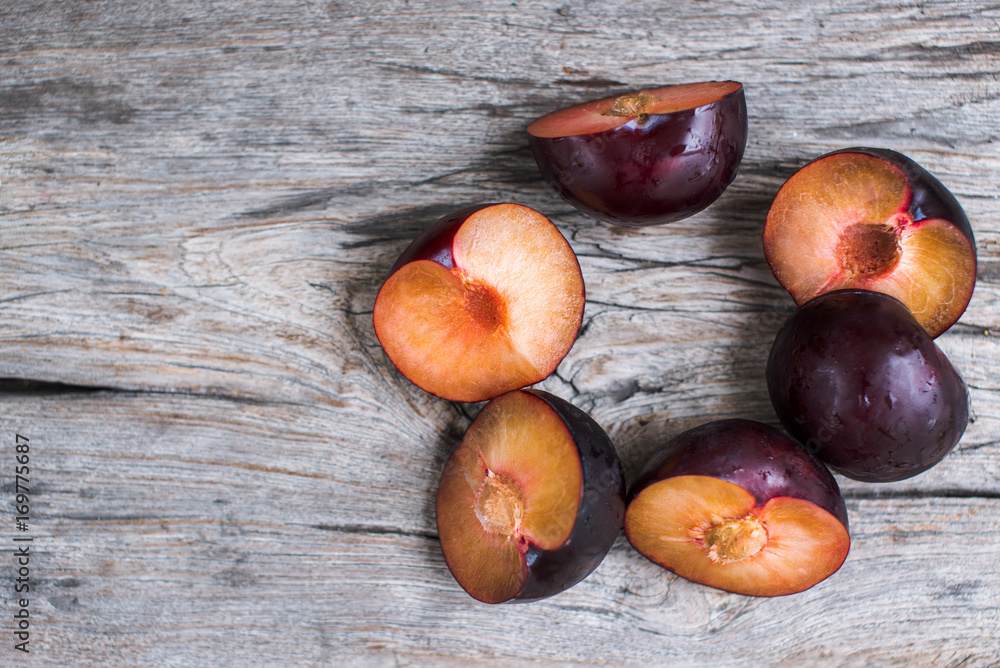 Obraz premium plums on the wooden table lying in a circle