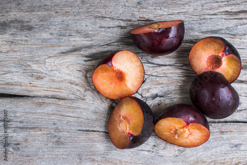 plums on the wooden table lying in a circle