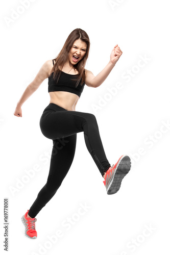 Sports woman in rage runs on white background