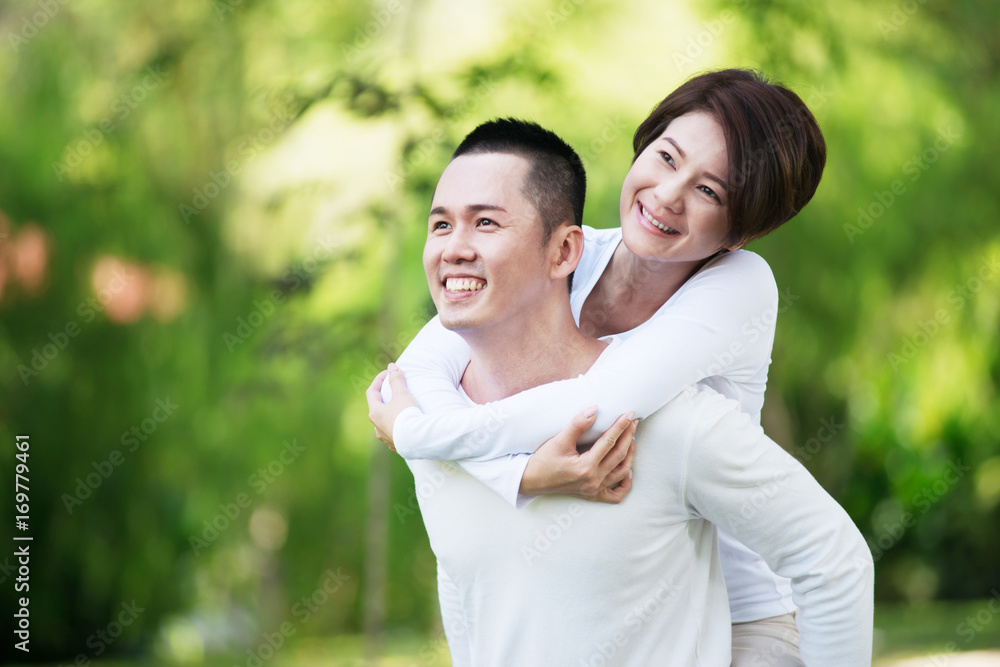 Young happy Asian couple spending time together at the park. Young happy Asian couple spending time together at the park.
