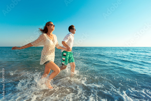 Happy young couple enjoying the sea