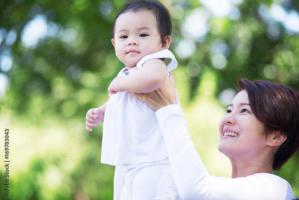 Young happy Asian mother and daughter spending time together at the park. Young happy Asian mother and daughter spending time together at the park.