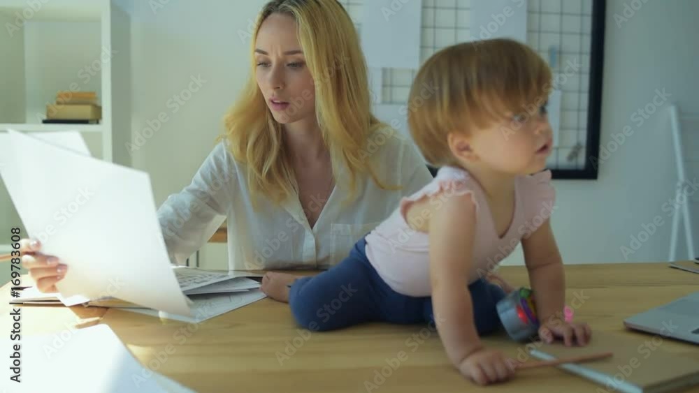Busy concentrated mom working at home Busy concentrated mom working at home