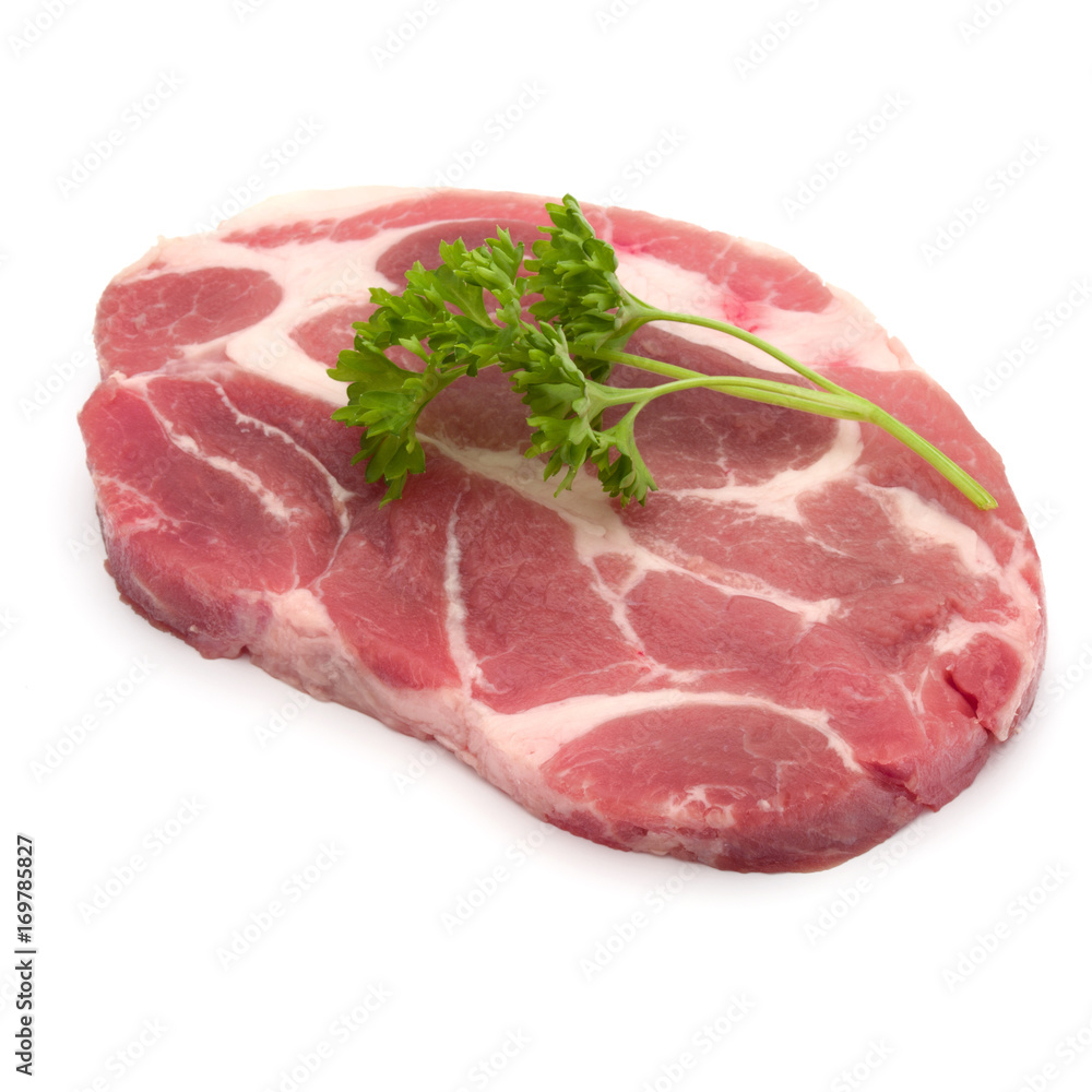 Raw pork neck chop meat with parsley herb leaves garnish isolated on white background cutout Raw pork neck chop meat with parsley herb leaves garnish isolated on white background cutout