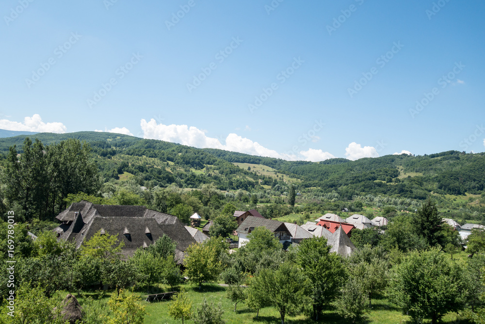 View of nearby village from Barsana wooden monastery, Maramures, Romania. Barsana monastery is one of the main point of interest in Maramures area.
