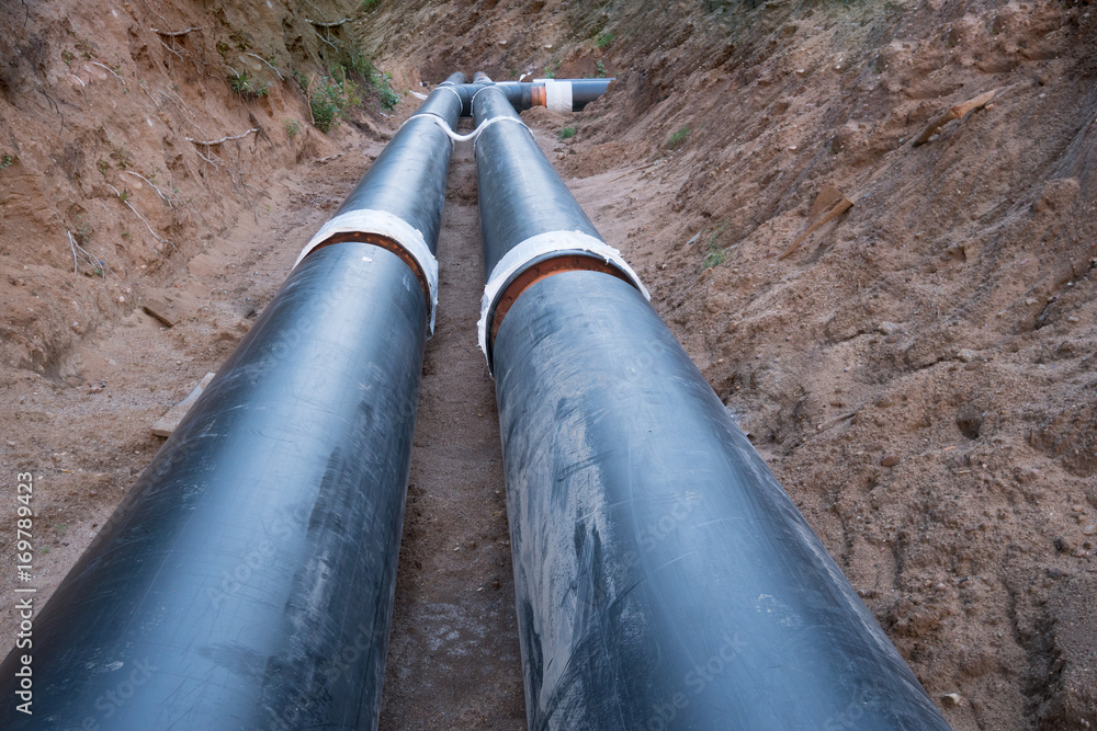 Laying of heating pipeline in the trench to provide new houses with hot water Laying of heating pipeline in the trench to provide new houses with hot water