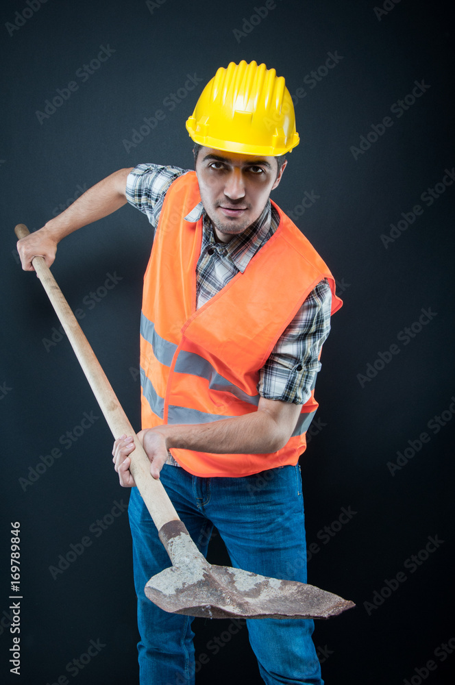 Constructor wearing equipment holding hoe like digging Constructor wearing equipment holding hoe like digging