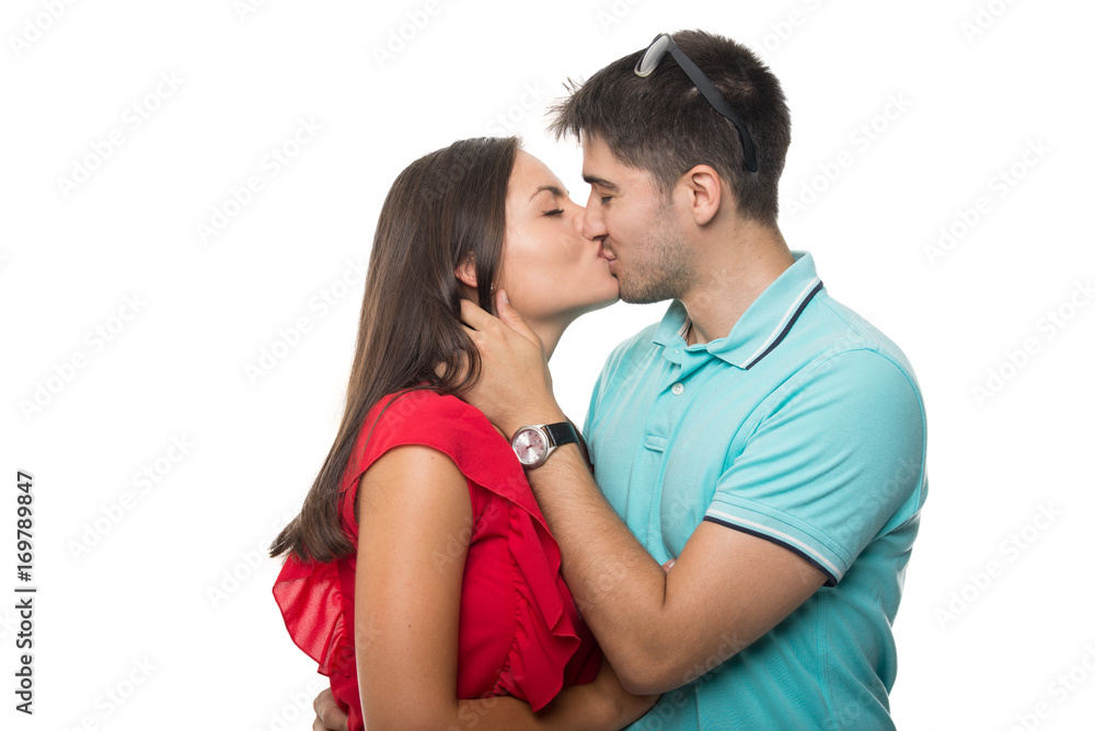 Attractive young couple embracing and kissing Attractive young couple embracing and kissing
