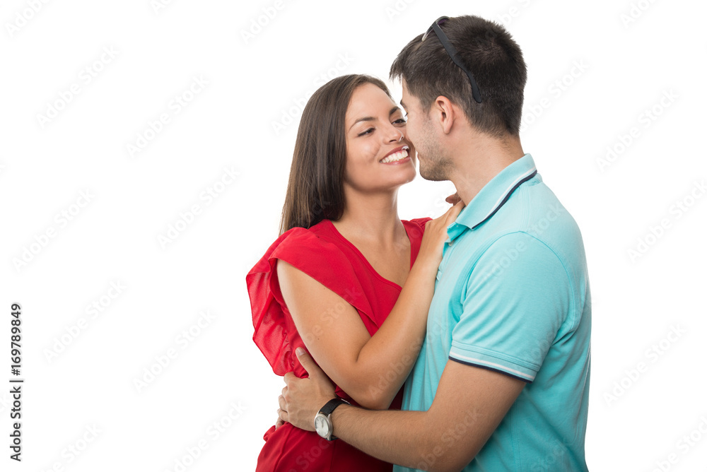 Handsome young couple embracing looking happy Handsome young couple embracing looking happy