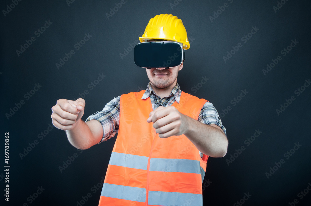 Constructor wearing vr goggles gesturing driving car Constructor wearing vr goggles gesturing driving car