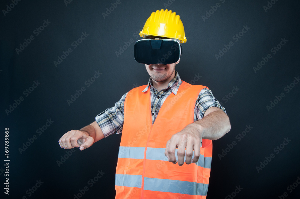 Constructor wearing vr goggles gesturing driving car Constructor wearing vr goggles gesturing driving car