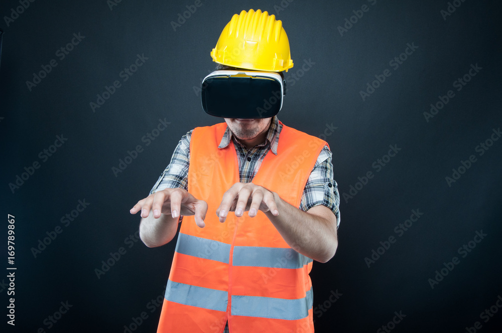 Constructor wearing vr goggles gesturing keyboard with hands Constructor wearing vr goggles gesturing keyboard with hands