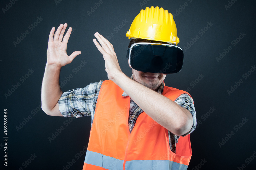 Constructor wearing vr goggles gesturing with hands Constructor wearing vr goggles gesturing with hands