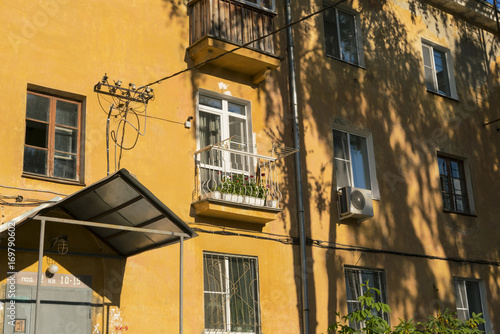Modern balcony on the old yellow building.