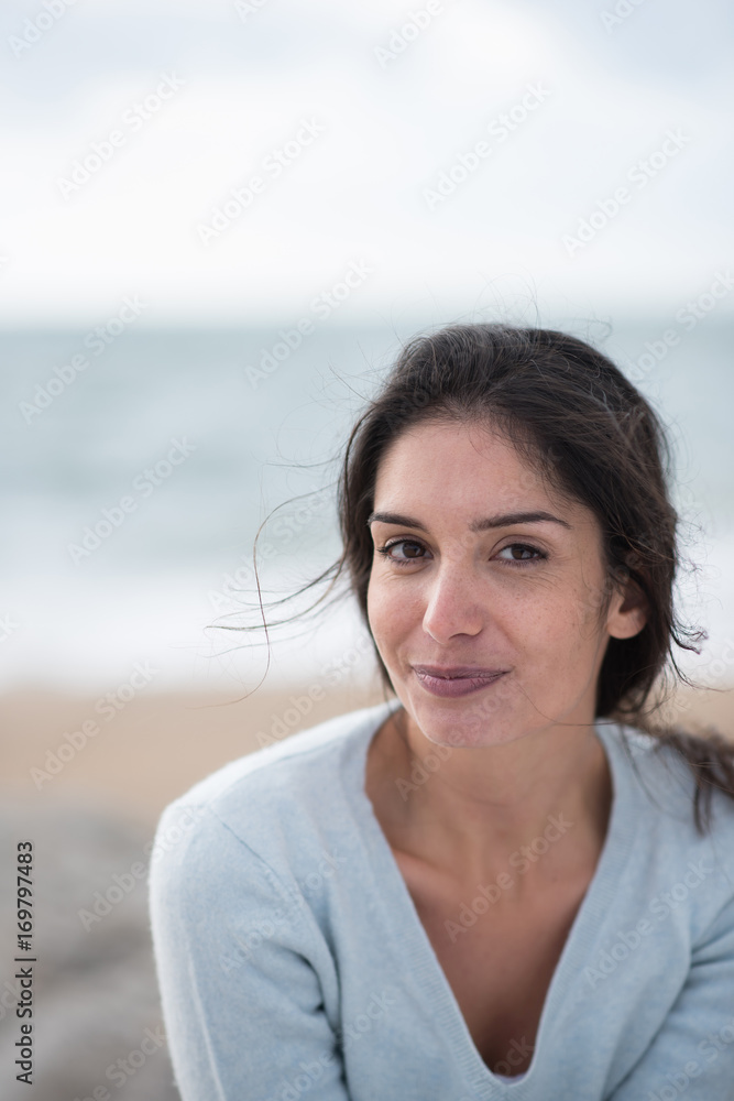 Portrait of a beautiful young brunette woman on the beach Portrait of a beautiful young brunette woman on the beach