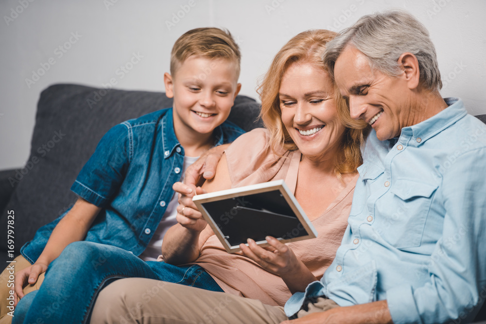 family looking at photo frame family looking at photo frame