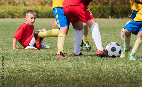 Fototapeta Naklejka Na Ścianę i Meble -  Kids soccer football - children players match on soccer field