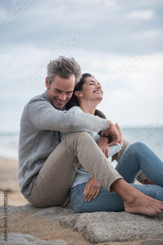 Portrait of a middle-aged couple sitting on the beach © jackfrog