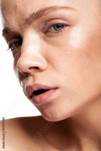 Gorgeous beautiful woman with wet face. Studio photo. Beauty and skin care