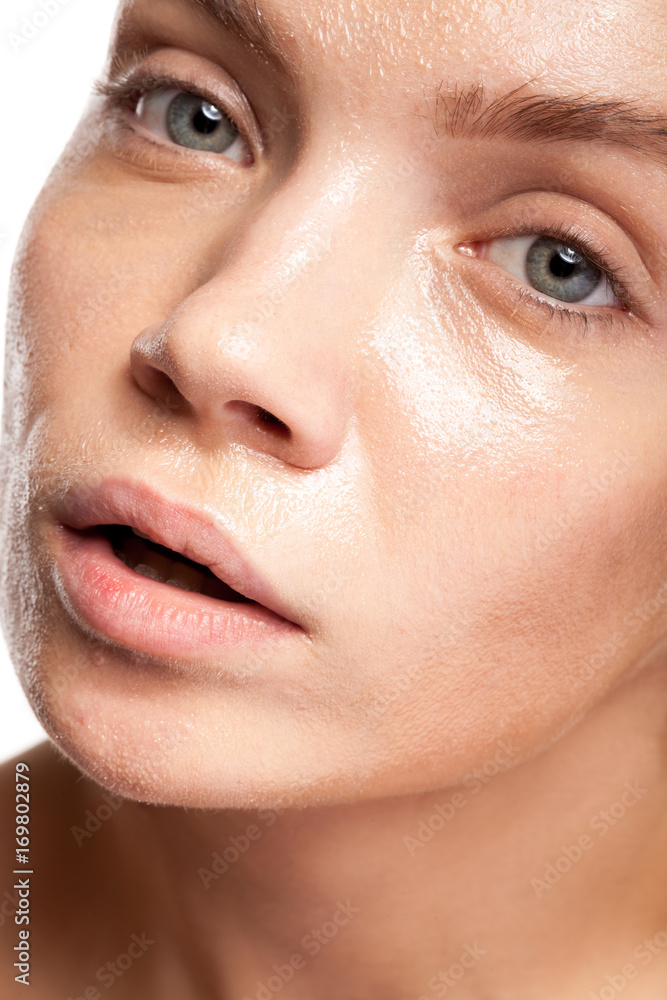 Fototapeta premium Beautiful woman with wet face. Studio photo. Beauty and skin care