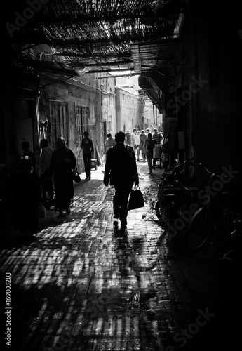 Marrakech man walking in shadow