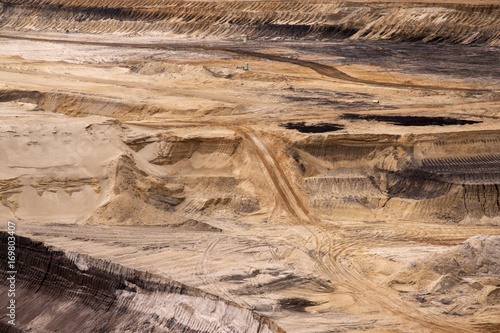 Germany, North Rhine Westphalia, -june 2017:  ground excavator in action moving mullock and soil at open pit coal mine; Germany,for winning brown coal photo