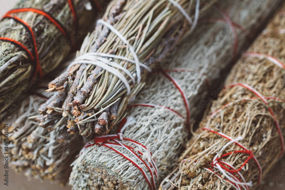 Close-up of the bandaged branches of dried herbs: sage, wormwood, pine and juniper