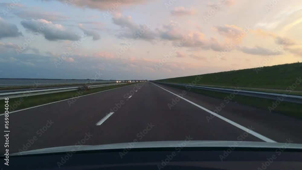 View from a car on the highway ahead during dusk View from a car on the highway ahead during dusk