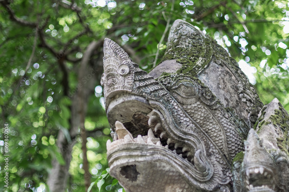 Close up of old serpent statue in temple