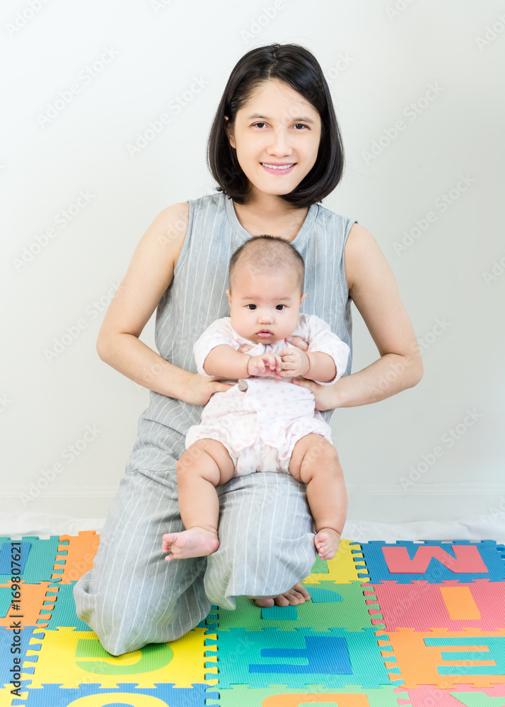 Portrait of happy asian mother hugging her cute baby Portrait of happy asian mother hugging her cute baby