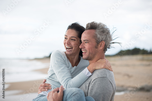  middle-aged couple walking on the beach
