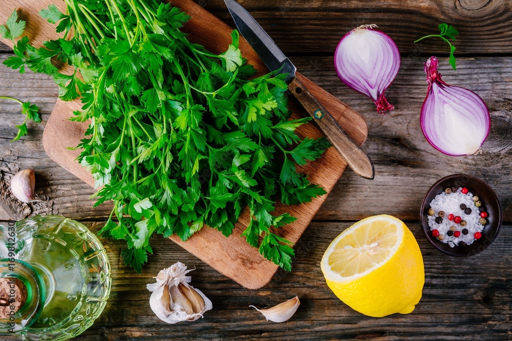 Ingredients for chimichurri sauce: fresh parsley, red onion, garlic, olive oil, lemon Ingredients for chimichurri sauce: fresh parsley, red onion, garlic, olive oil, lemon