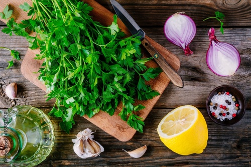 Ingredients for chimichurri sauce: fresh parsley, red onion, garlic, olive oil, lemon
