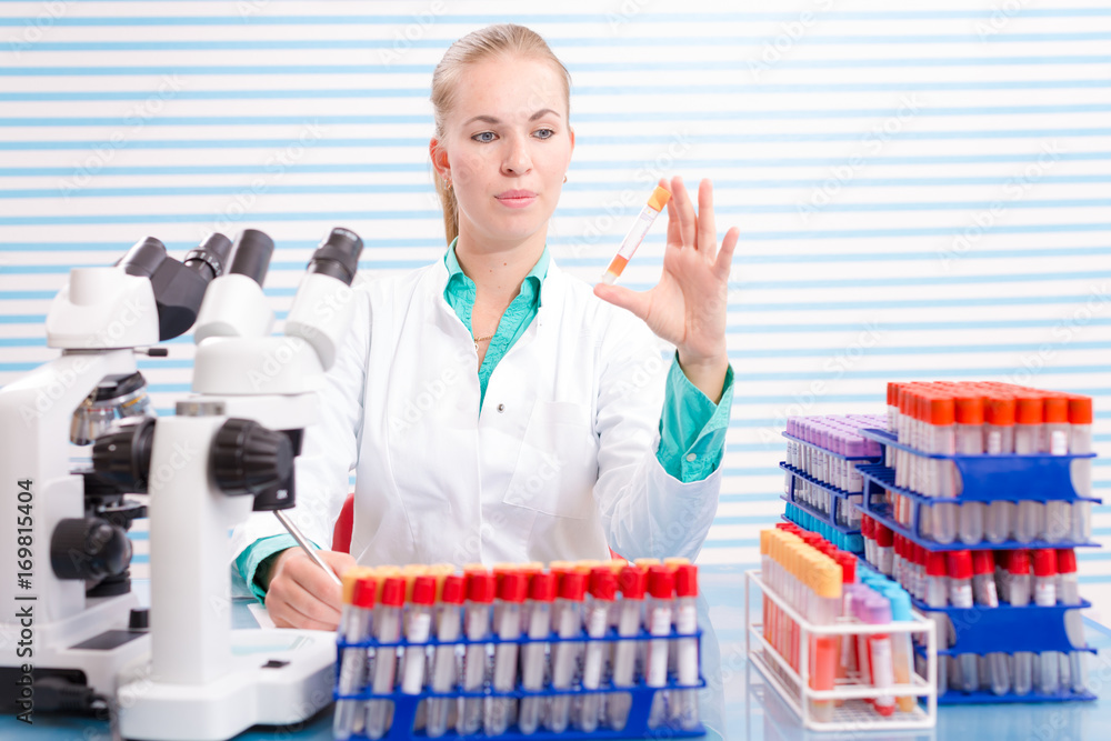 A nurse in a hospital laboratory tests a blood A nurse in a hospital laboratory tests a blood