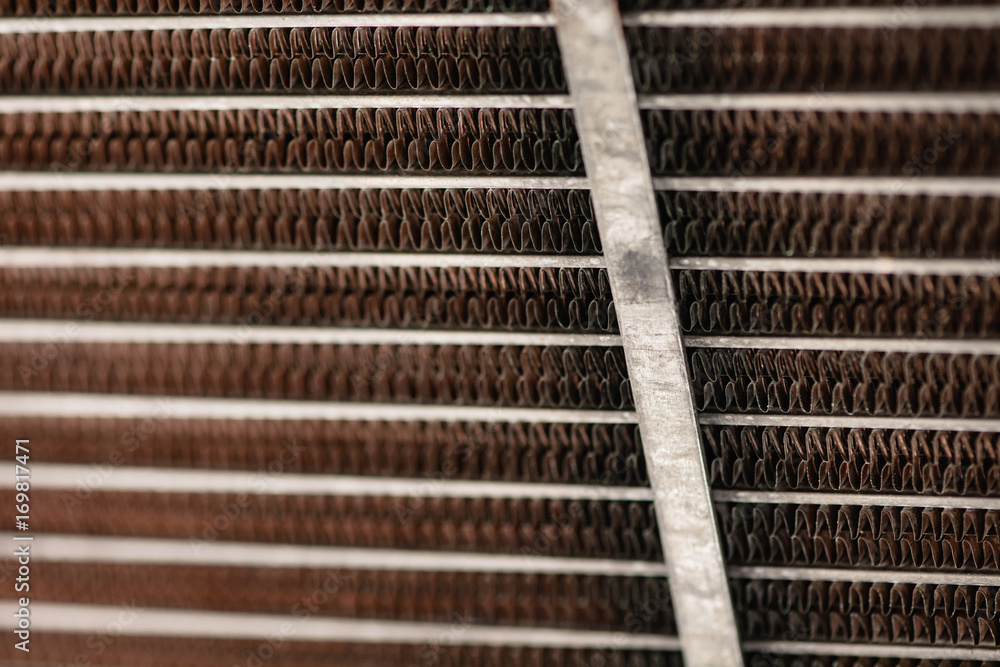 Old, rusty automotive cooler. Rusty, red lattice texture. Grid. Old, rusty automotive cooler. Rusty, red lattice texture. Grid.